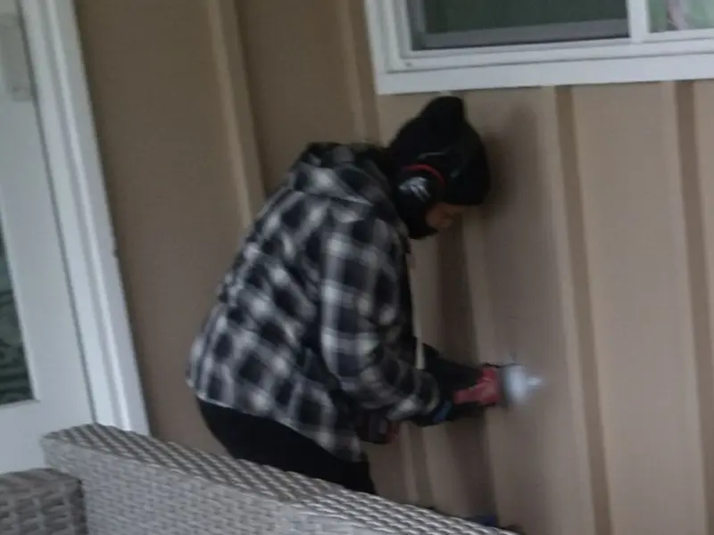 Professional electrician installing an exterior outlet in Olivette